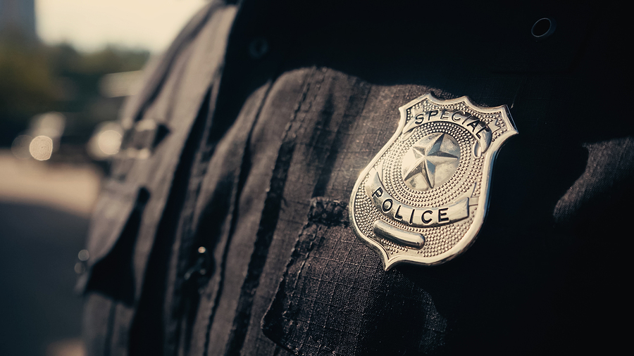 Special Police Lettering On Silver Badge And Black Uniform Of Cr