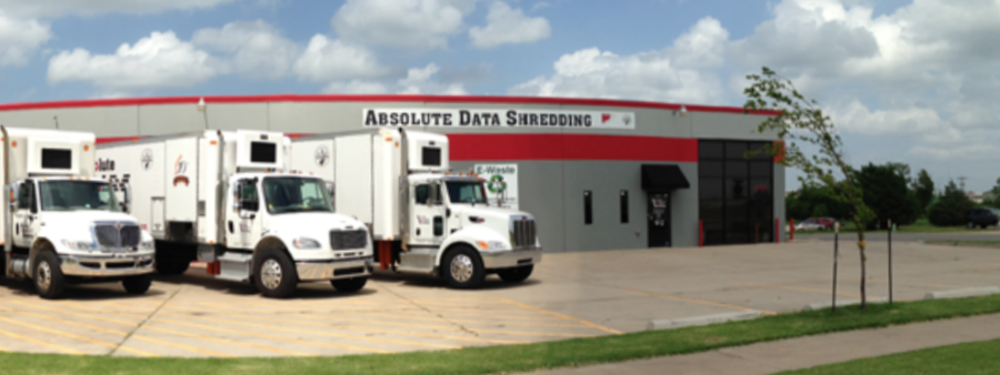 View from street of Absolute Data Shredding building in Norman, OK with 3 shredding trucks in the lot